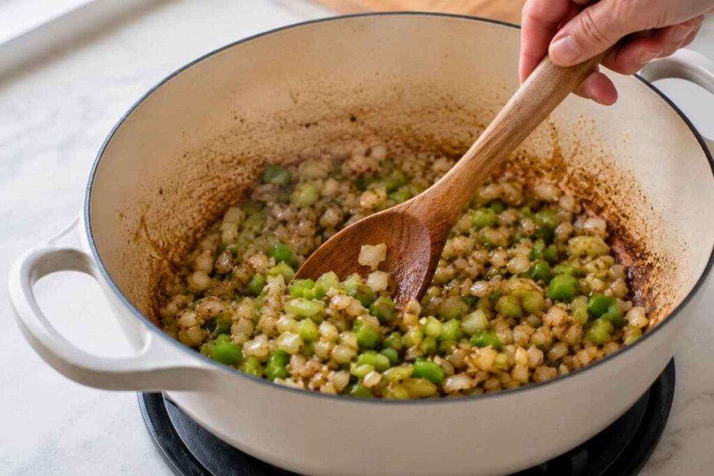 Sautéing onions, peppers, and celery — step 2 of making cajun potato soup
